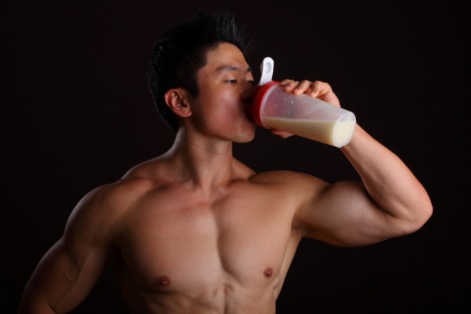 Bodybuilder drinking protein drink